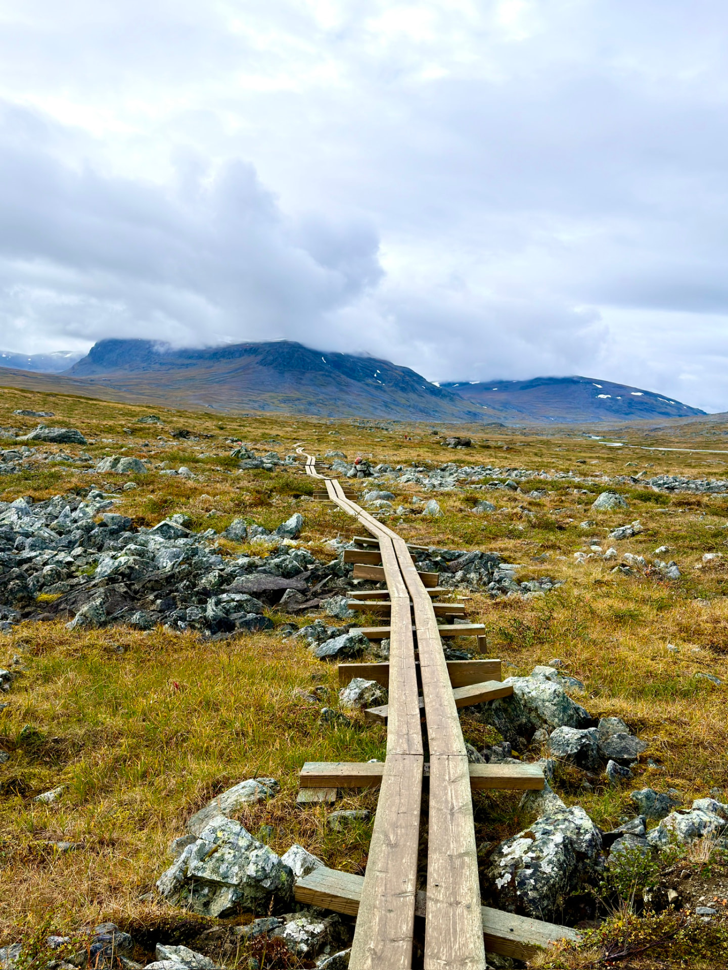 Wooden boardwalk winding through the rocky Swedish Lapland highlands