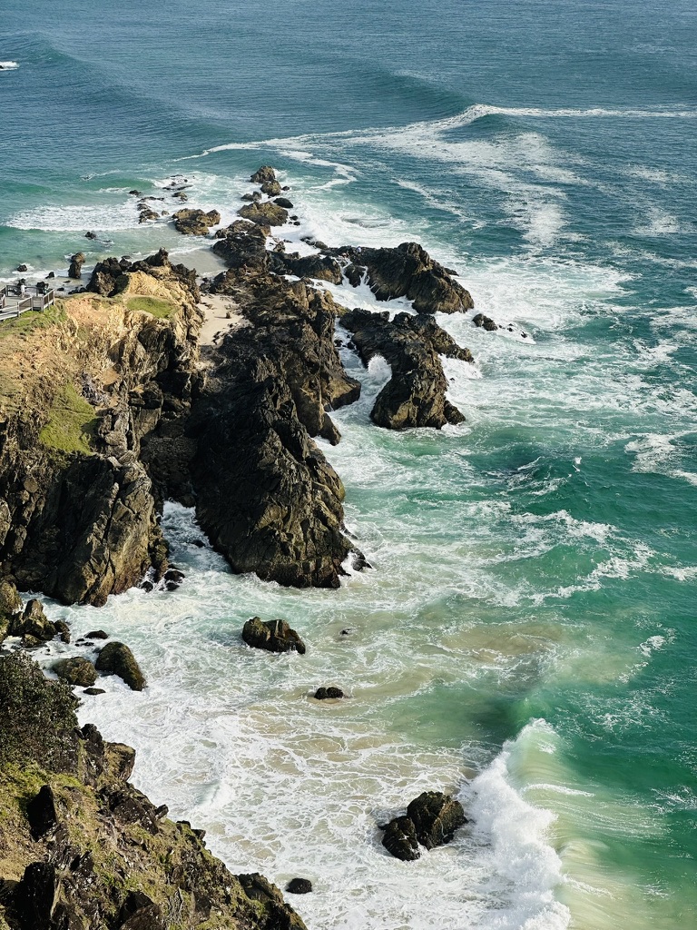 Ocean waves breaking around rugged Australian coastal cliffs