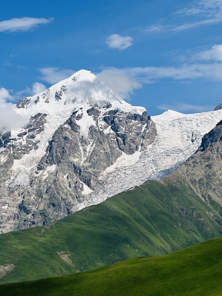 Snowbound glacier peak wreathed in cloud