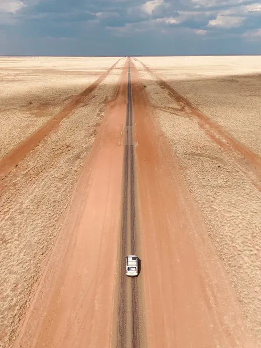 Australia route: a straight red dirt road through the Outback
