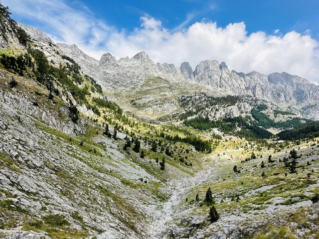 Peaks of the Balkans route: limestone peaks above a green valley