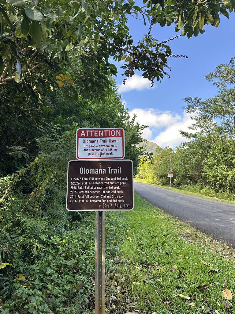 Trailhead warning sign listing fatal falls on the trail
