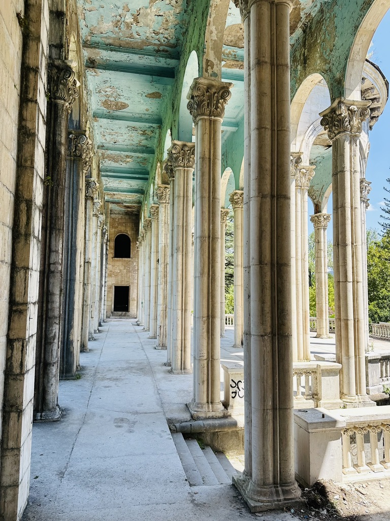 Weathered columned colonnade of an abandoned sanatorium