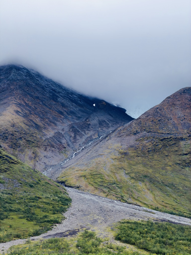 Cloud resting over a steep mountain pass in Swedish Lapland